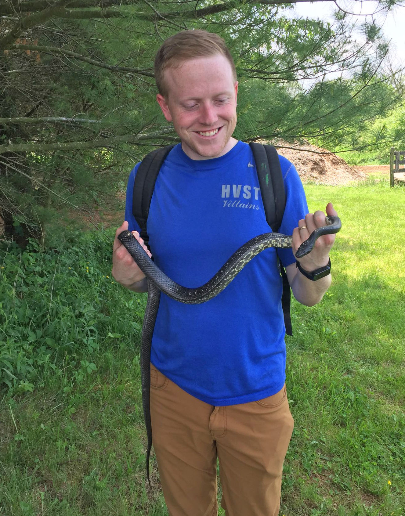 Photo of a man holding an Eastern Ratsnake